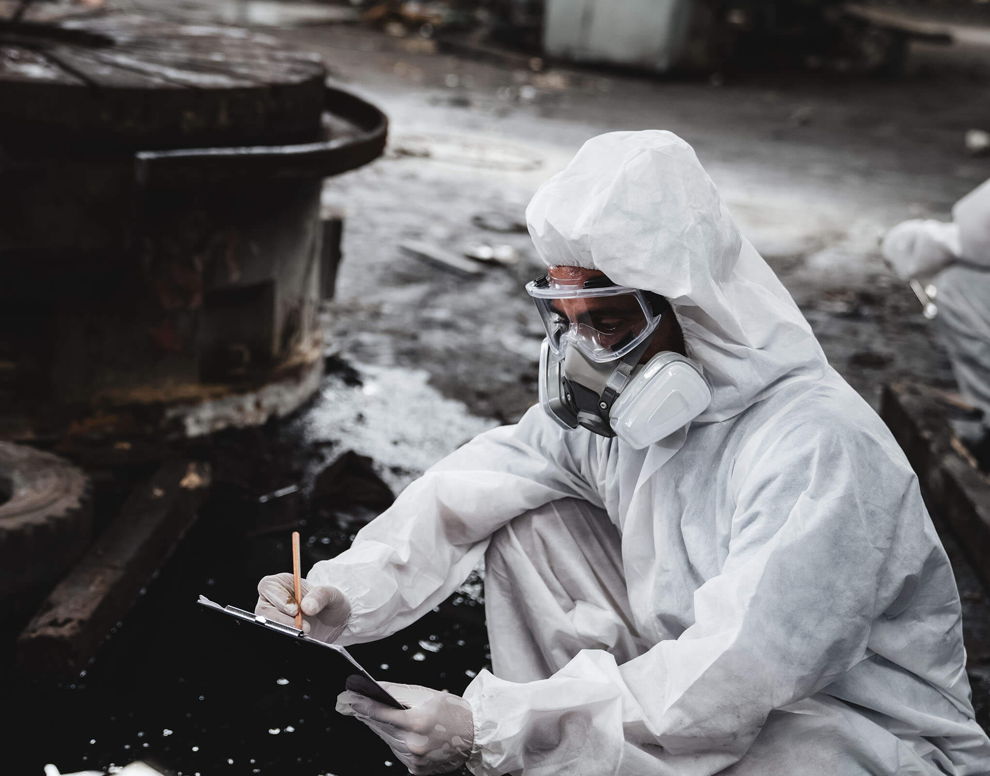 LCM Employee Inspecting an Fuel Spill in PPE