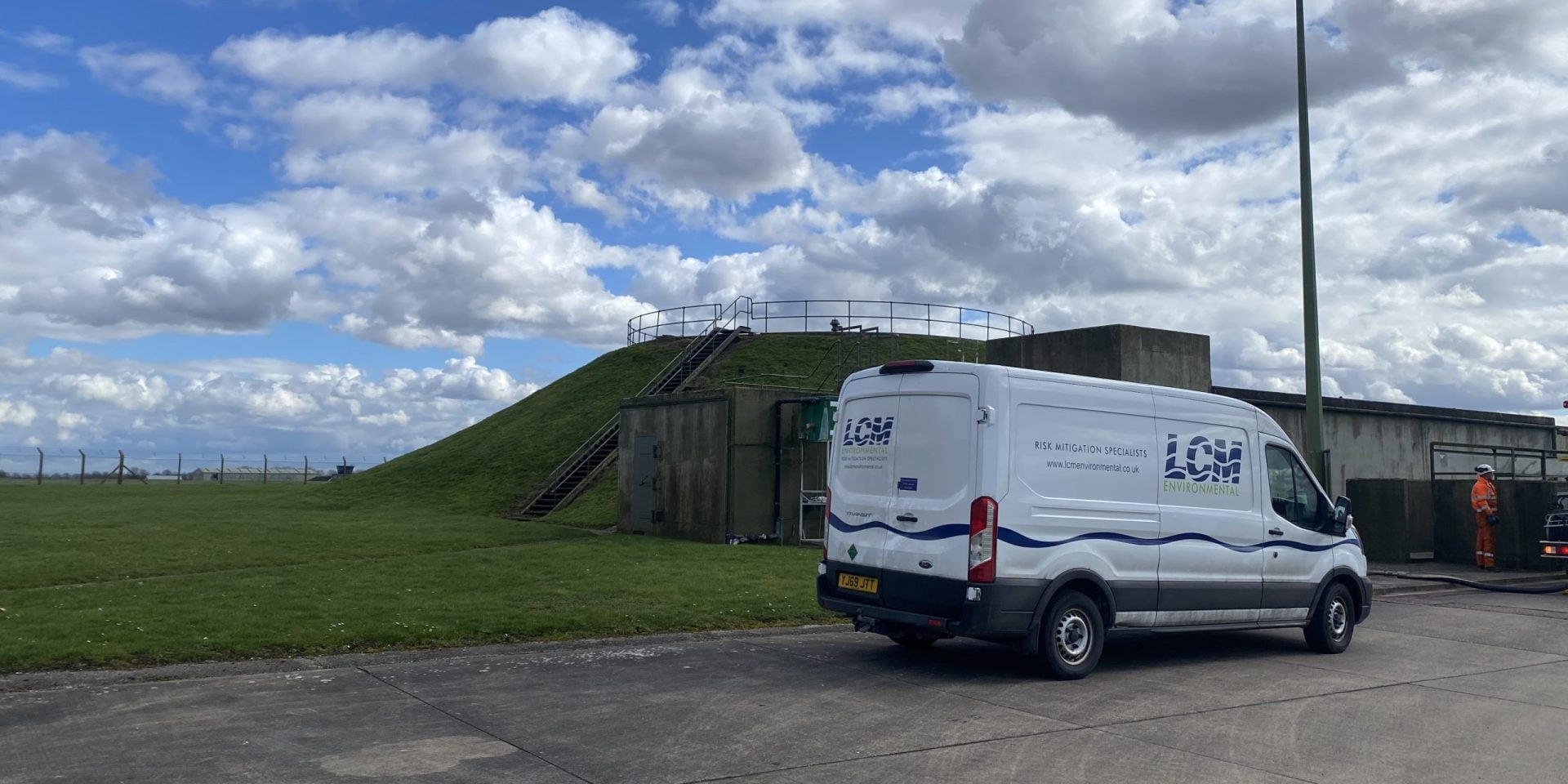 LCM white truck in front of outdoor compound