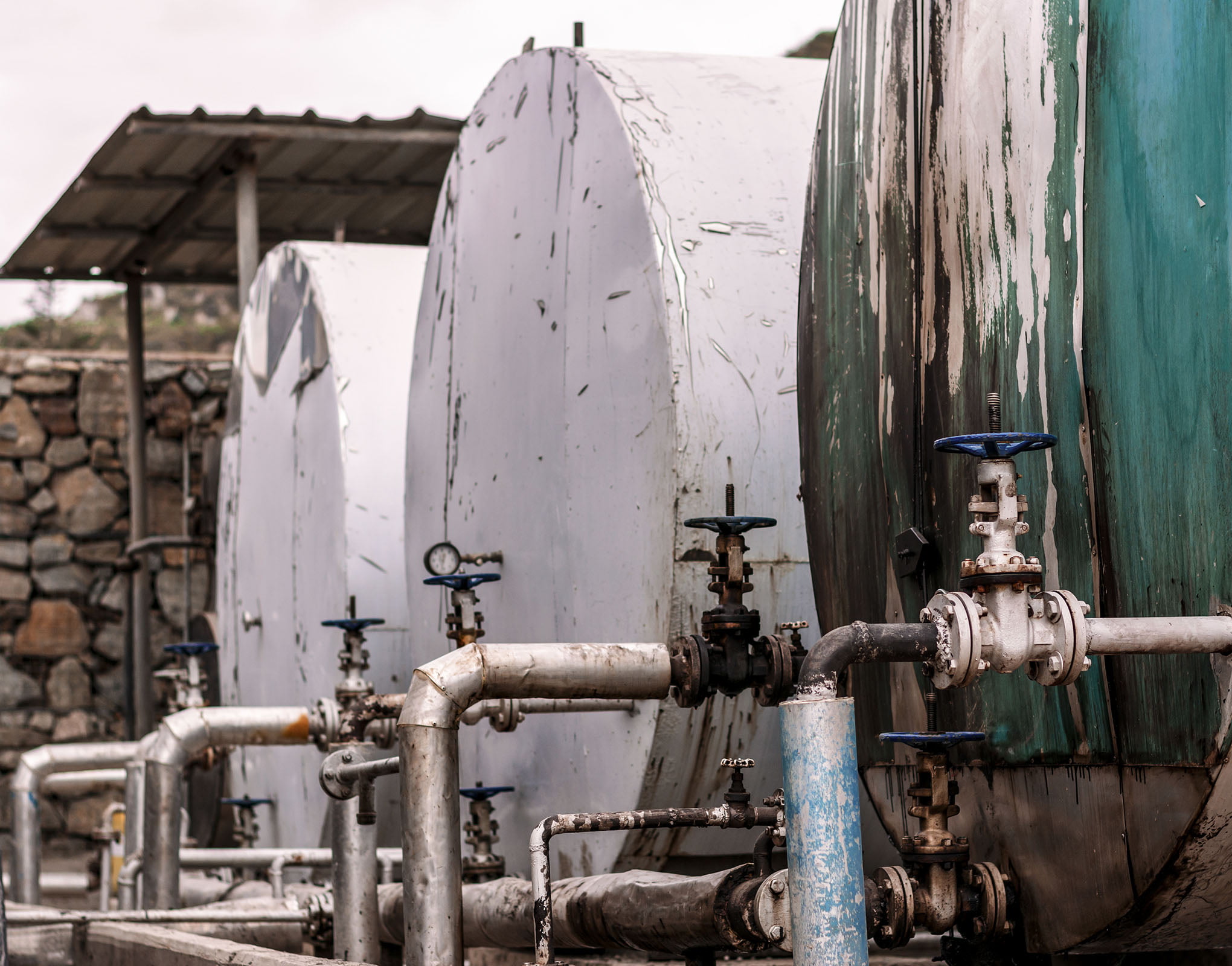 Old row of deteriorating fuel tanks