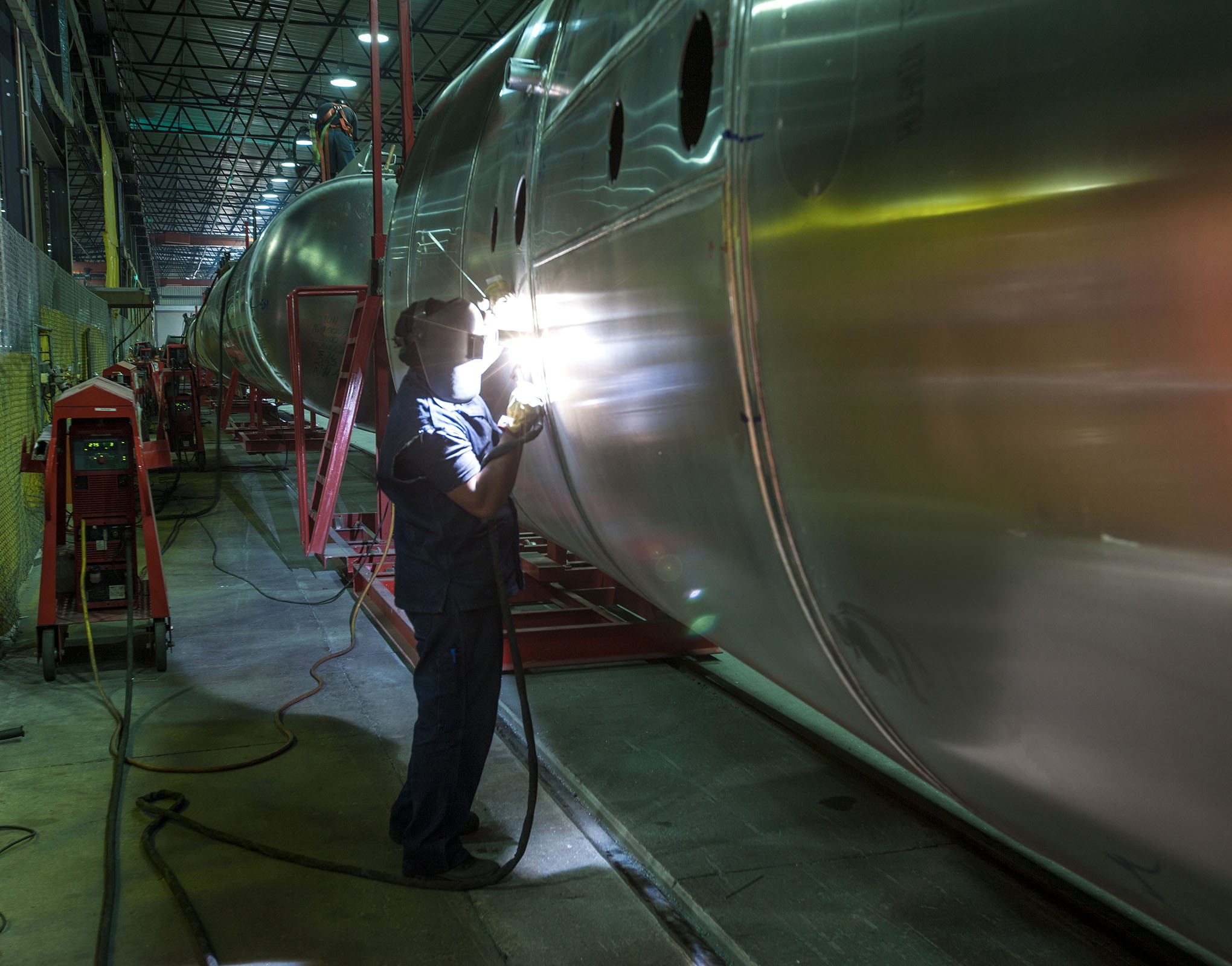 Worker welding a bespoke fuel tank