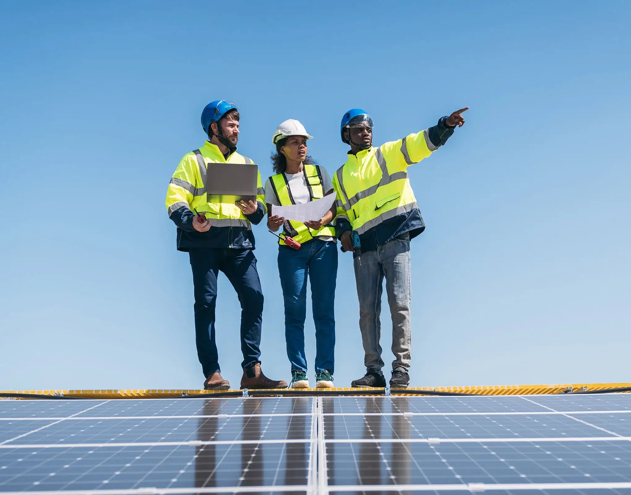 lcm team stood on roof for solar panel surveillance