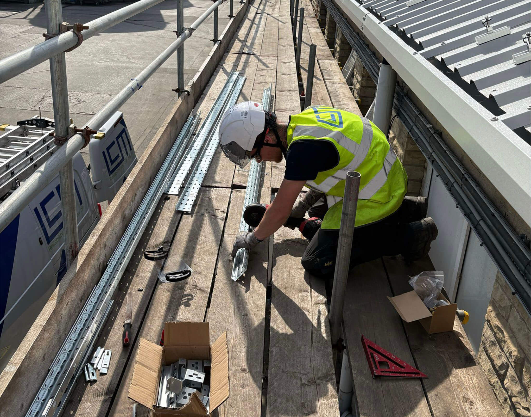 lcm-electrician-cutting-the-metal-for-the-solar-panels-to-sit-on